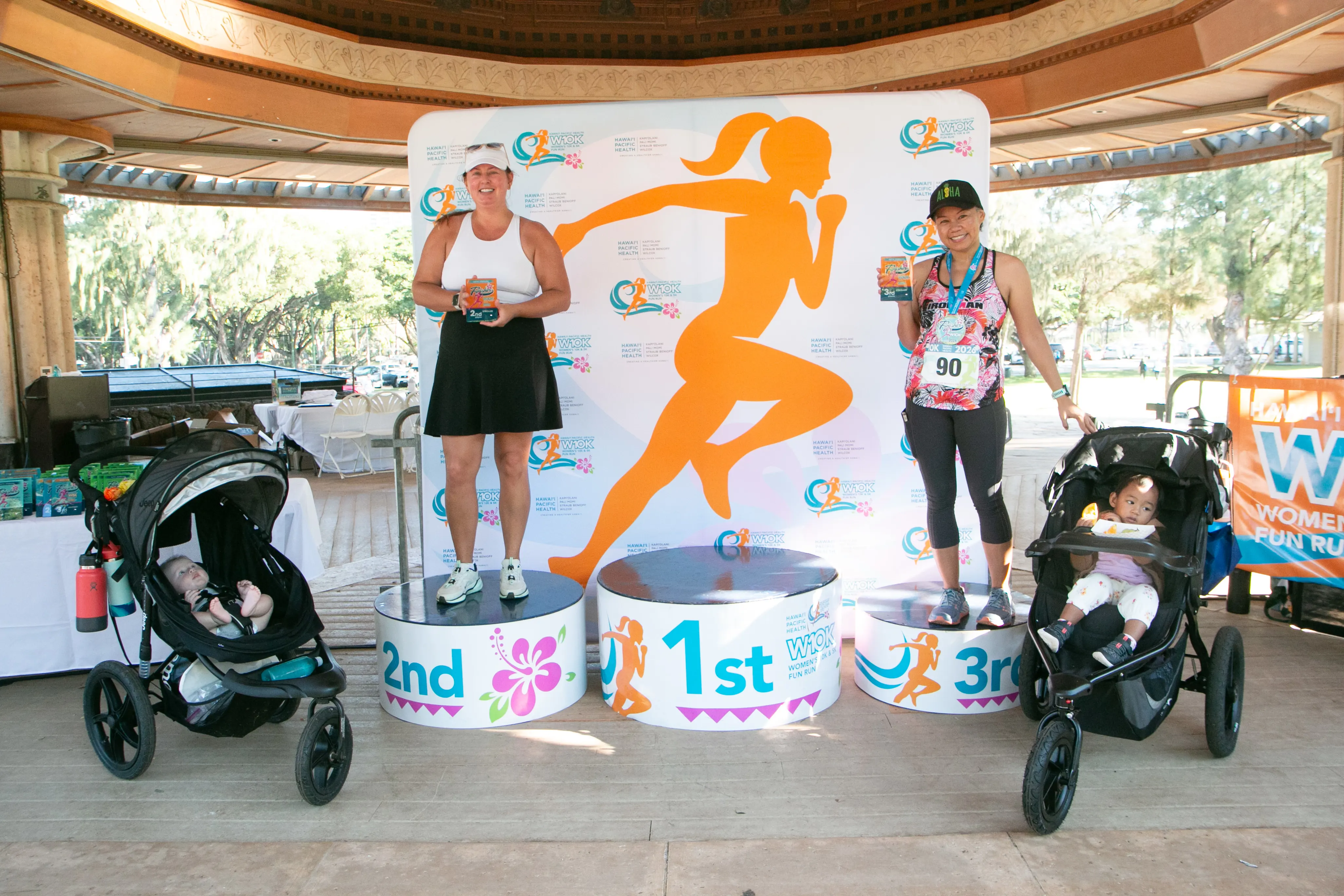 Stroller division winners standing on the winner podiums.