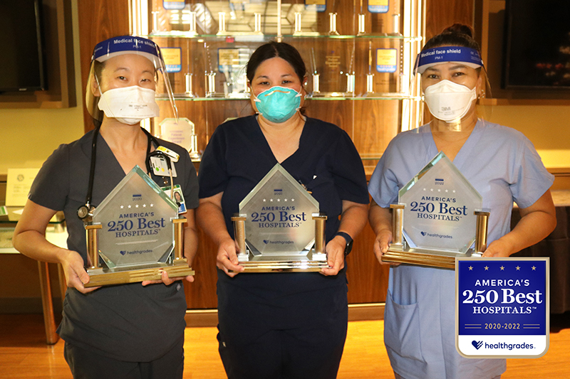 Three Straub medical professionals holding Healthgrades awards.