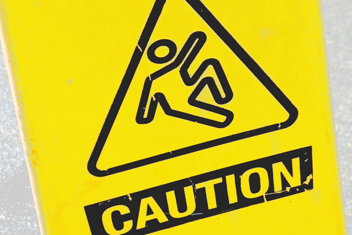 A yellow caution sign with the outline of a figure slipping.