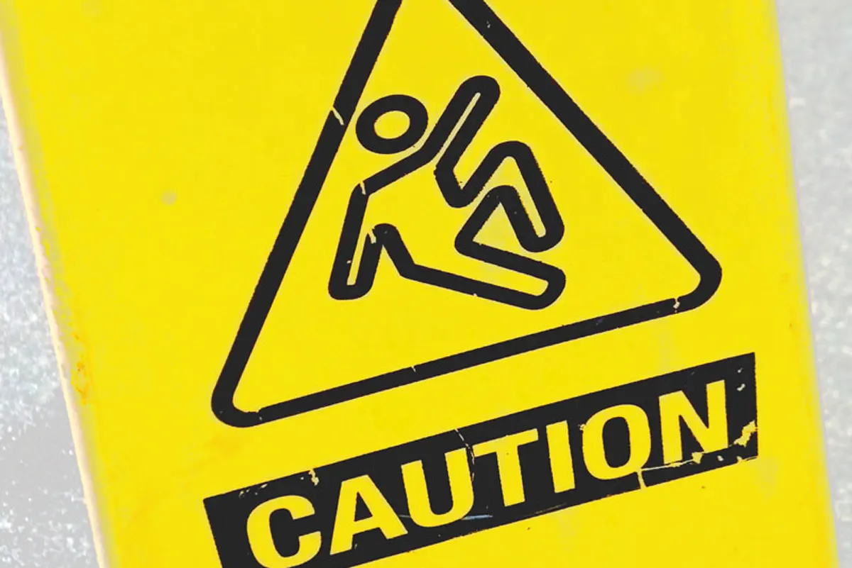 A yellow caution sign with the outline of a figure slipping.