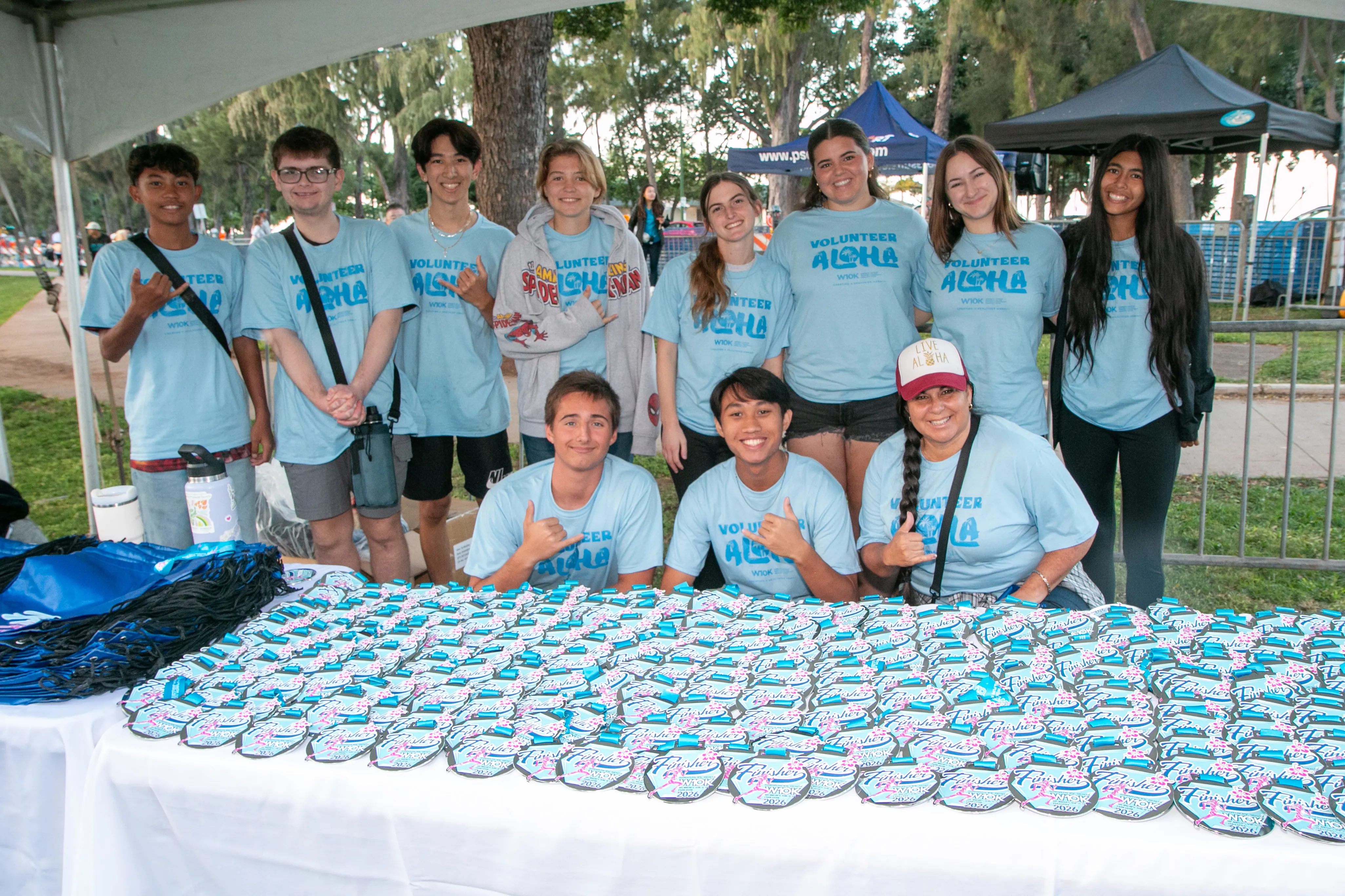 Group of volunteers ready to hand out finisher medals to the runners.