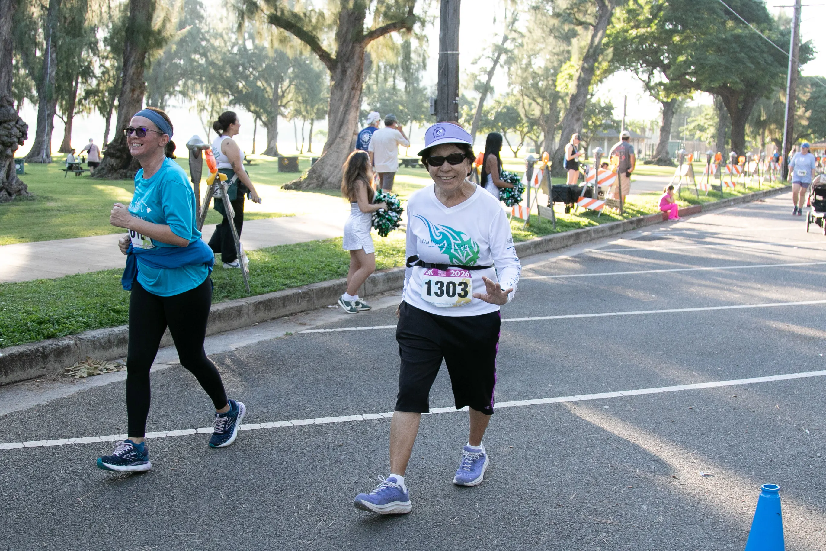 5K participant waving at the camera and smiling.