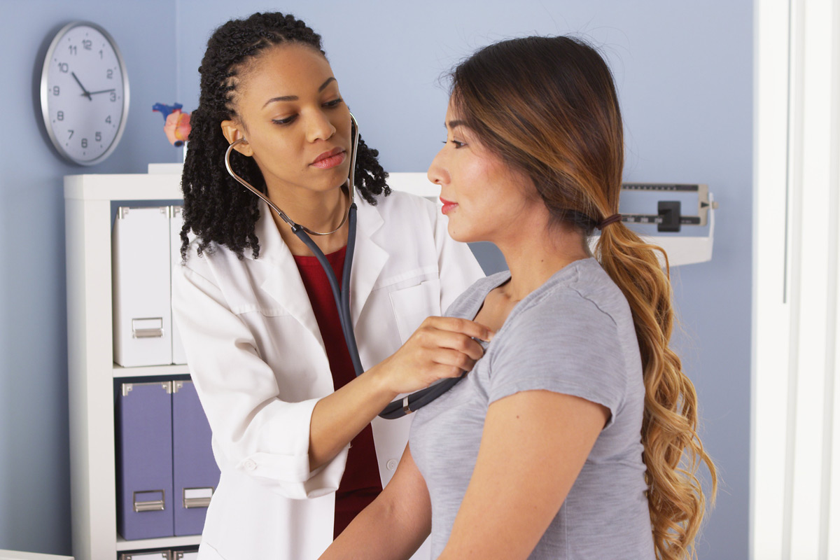 A woman getting her heart examined by doctor.