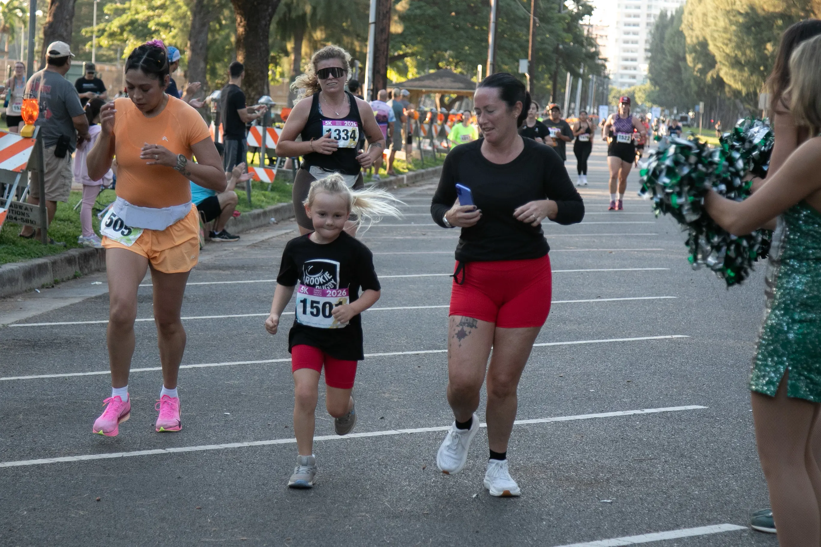Mother and daughter running towards the finish line together.
