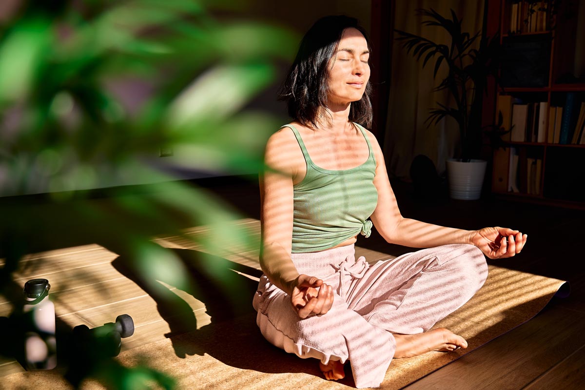 A young woman practices meditative breathing exercises.