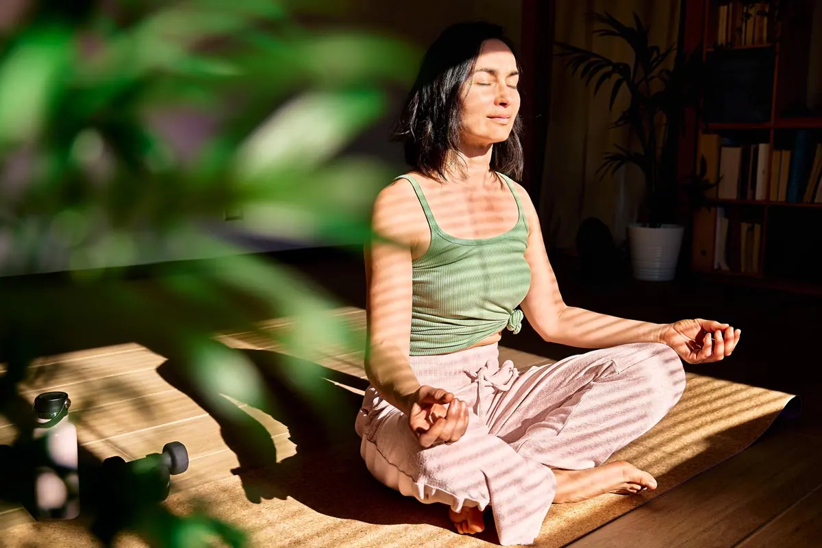 A young woman practices meditative breathing exercises.