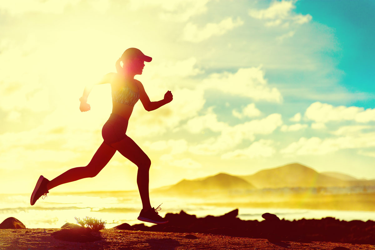 A woman running by the beach.