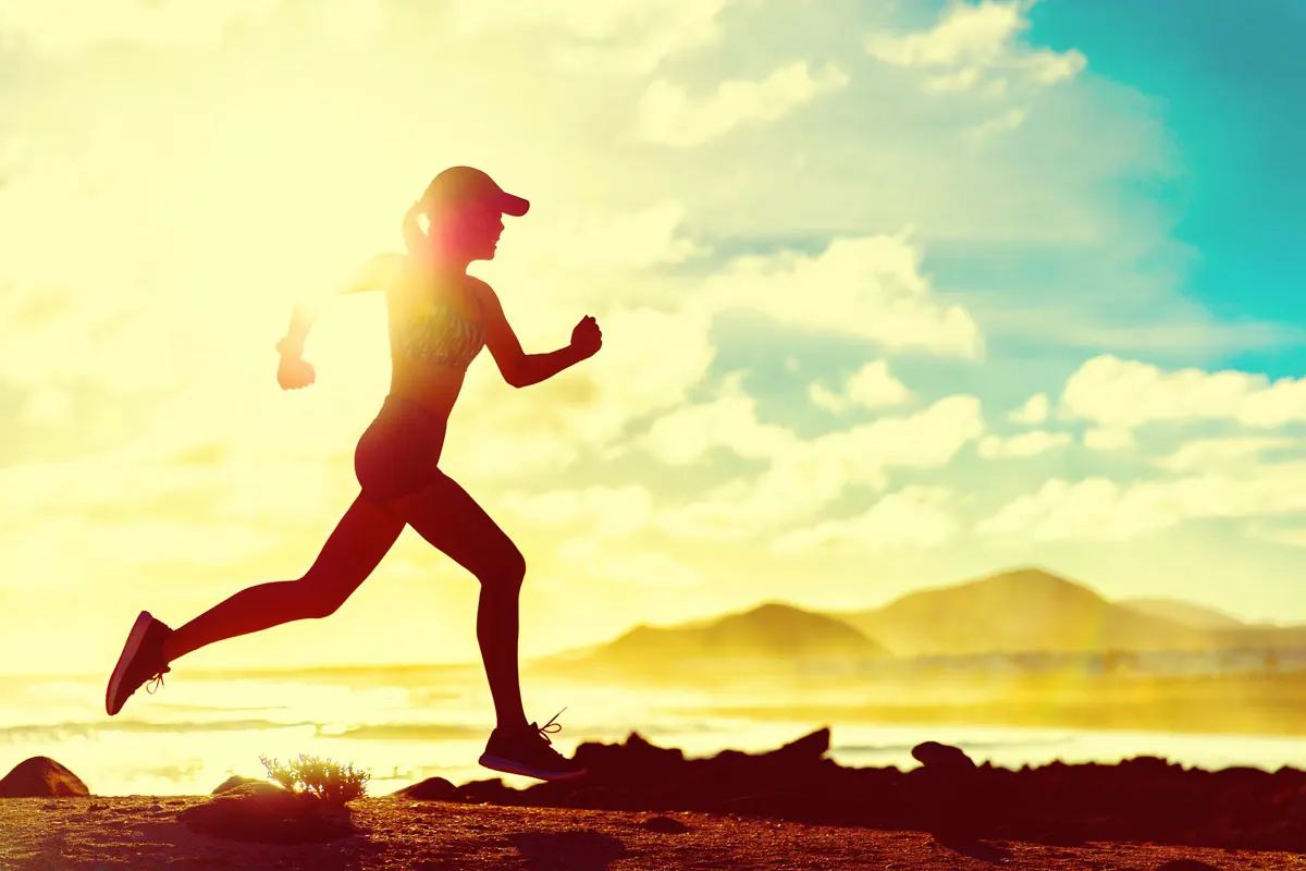 A woman running by the beach.