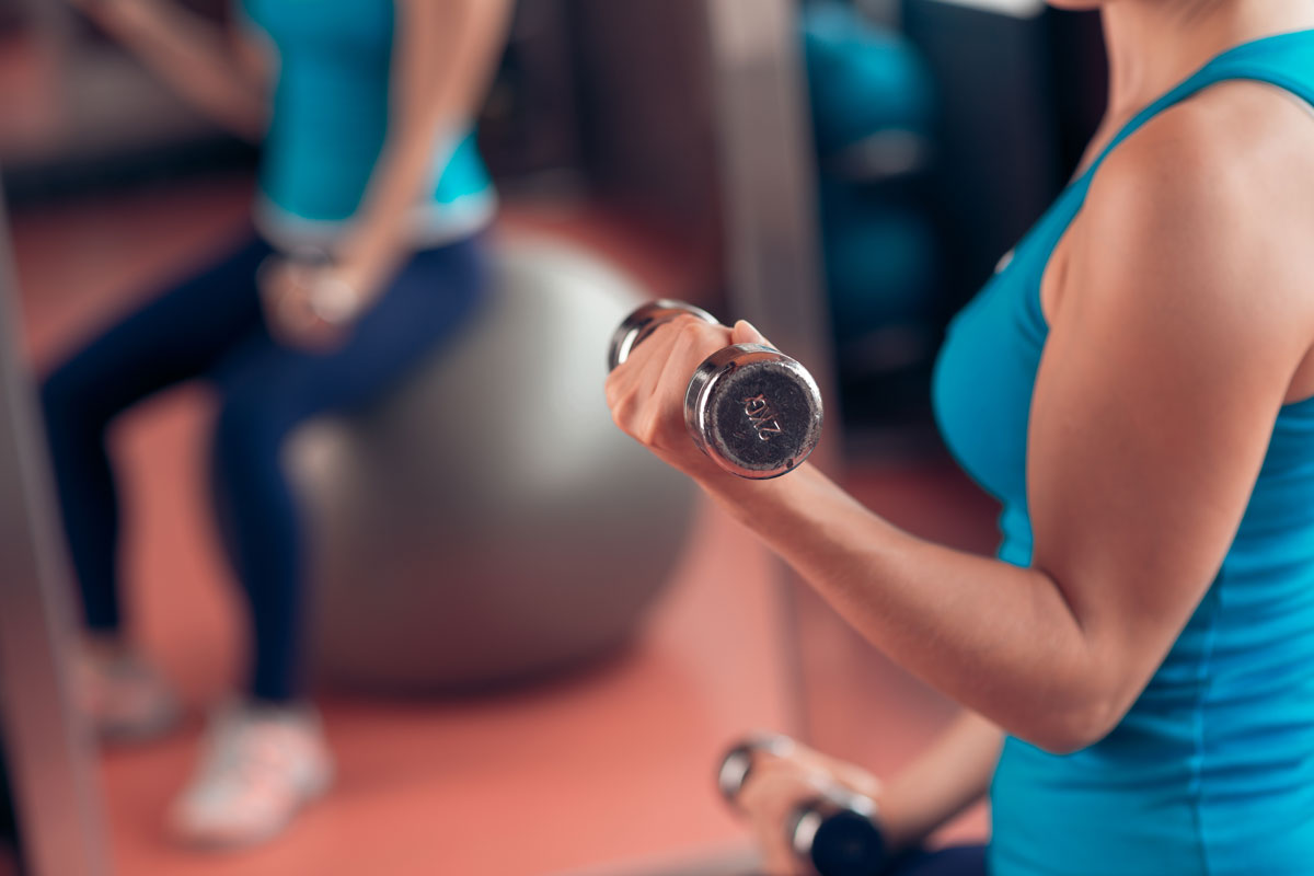 The arm of a person lifting weights.