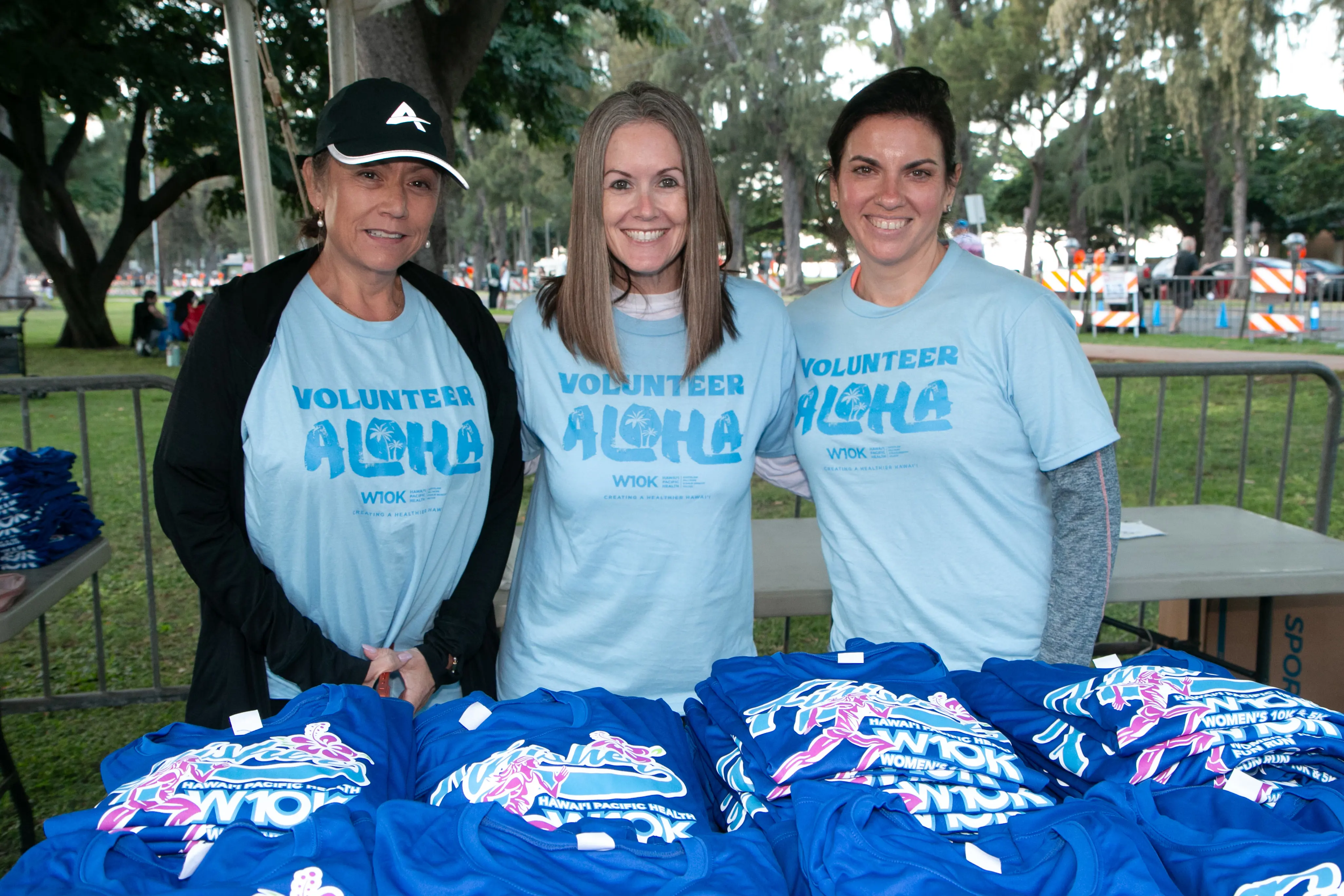 Volunteers ready to hand out finisher shirts to the runners.