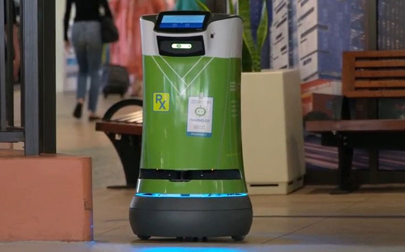 small green robot en route to deliver medications from the pharmacy.