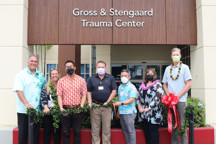 Group with masks in front of new Wilcox Medical Center Emergency Department.
