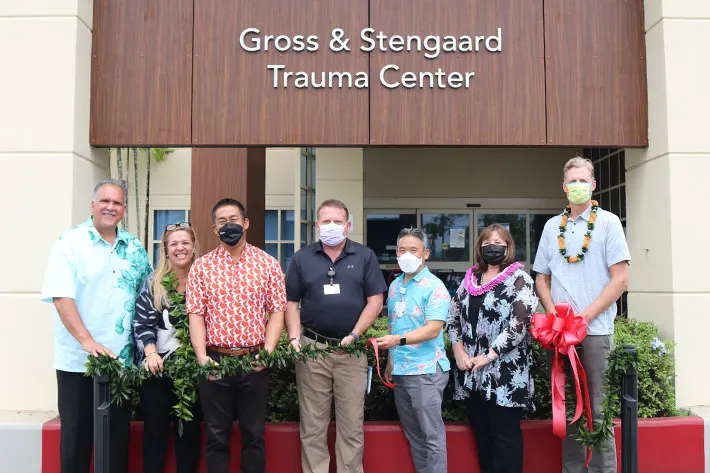 Group with masks in front of new Wilcox Medical Center Emergency Department.