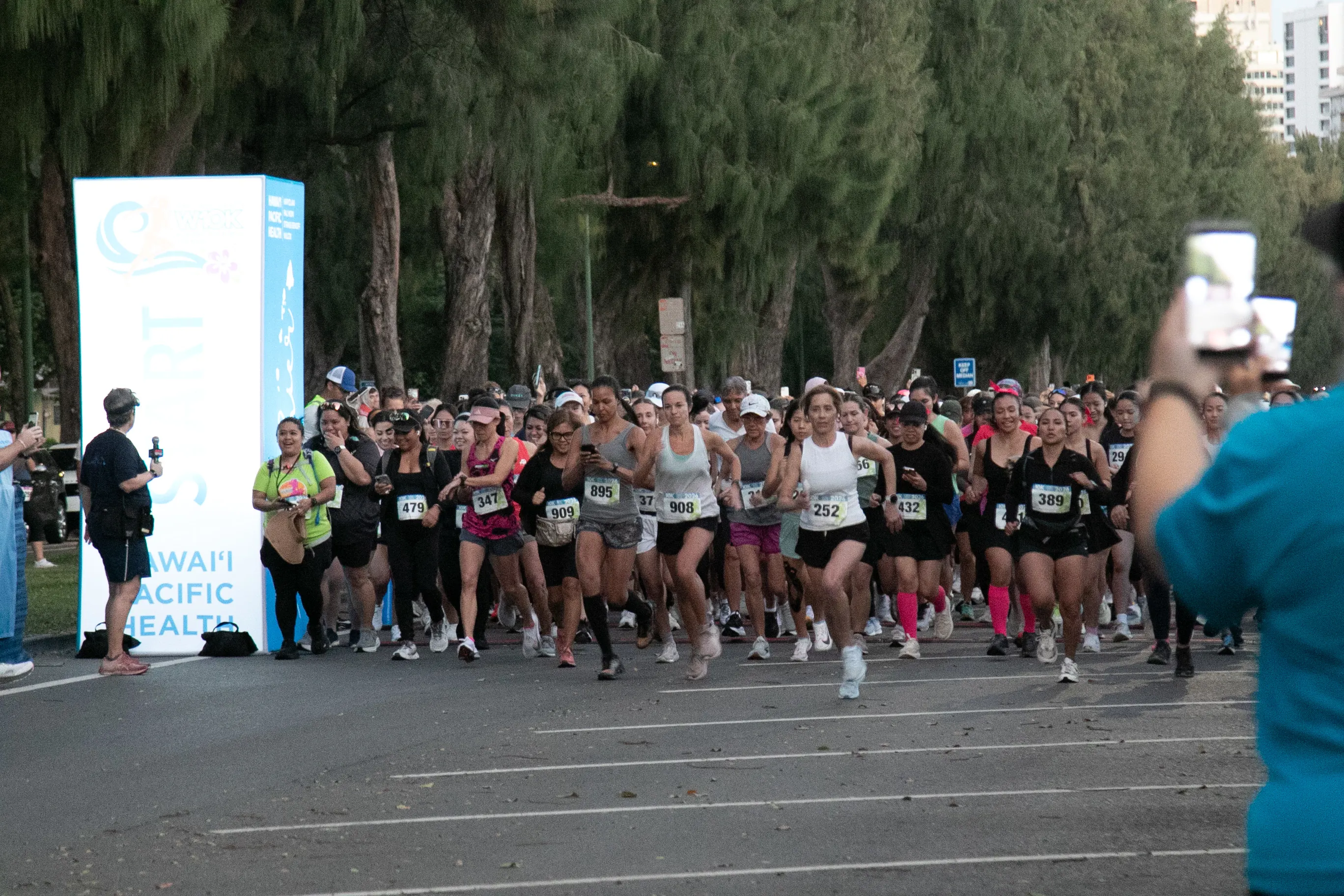 Large group of women gathered at the starting line of the race.