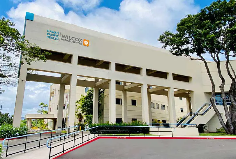 The exterior of the Wilcox Medical Center building under a blue sky.