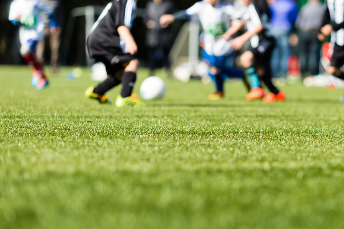 A group of children playing soccer together.