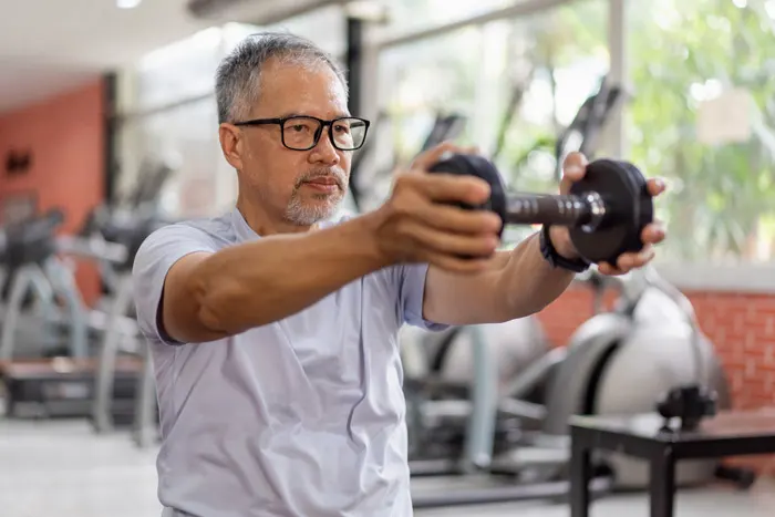 Man lifts a dumbbell in the gym.