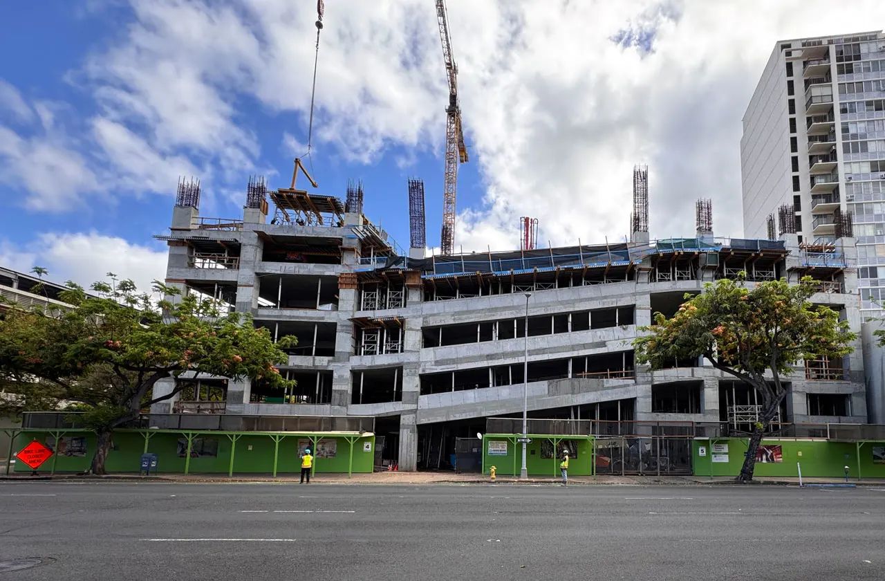 The parking structure rises.