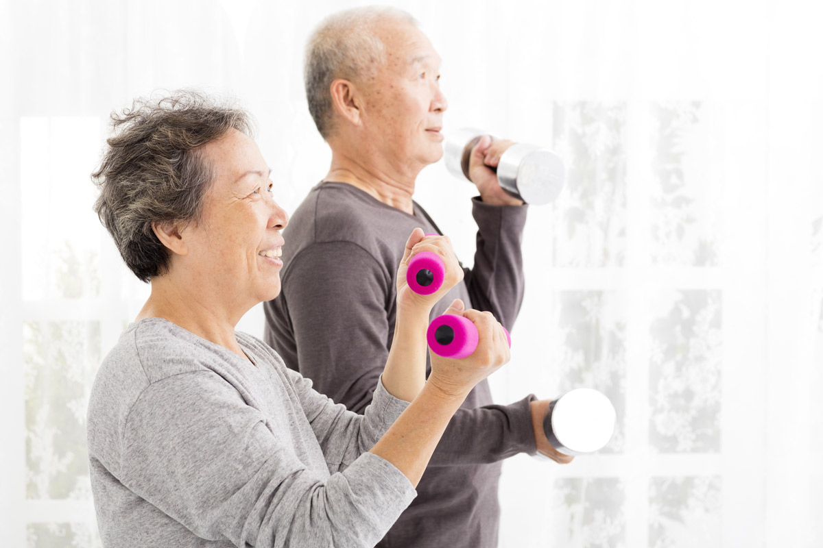 An elderly couple working out together.