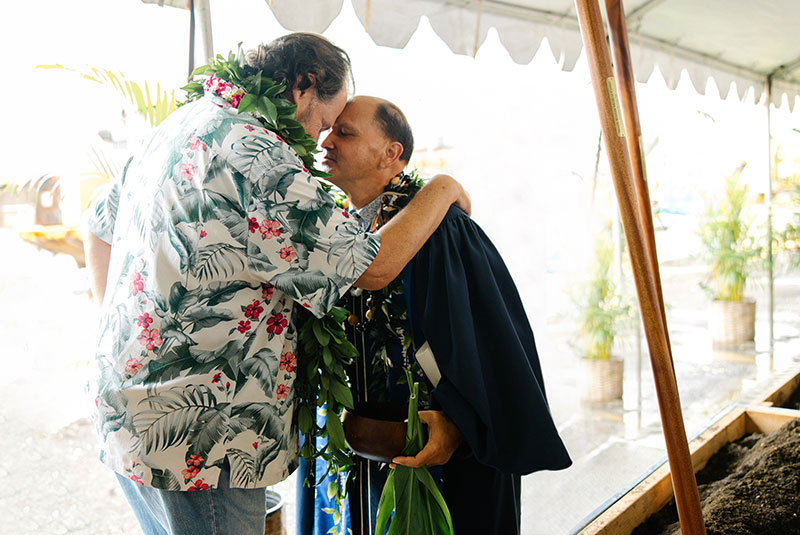 Two people embrace at a celebration.
