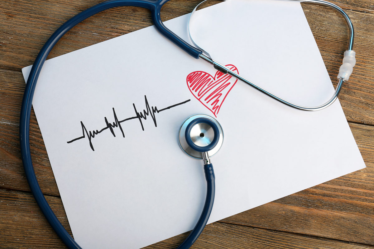 stock image of a stethoscope placed over a drawing of a heart.