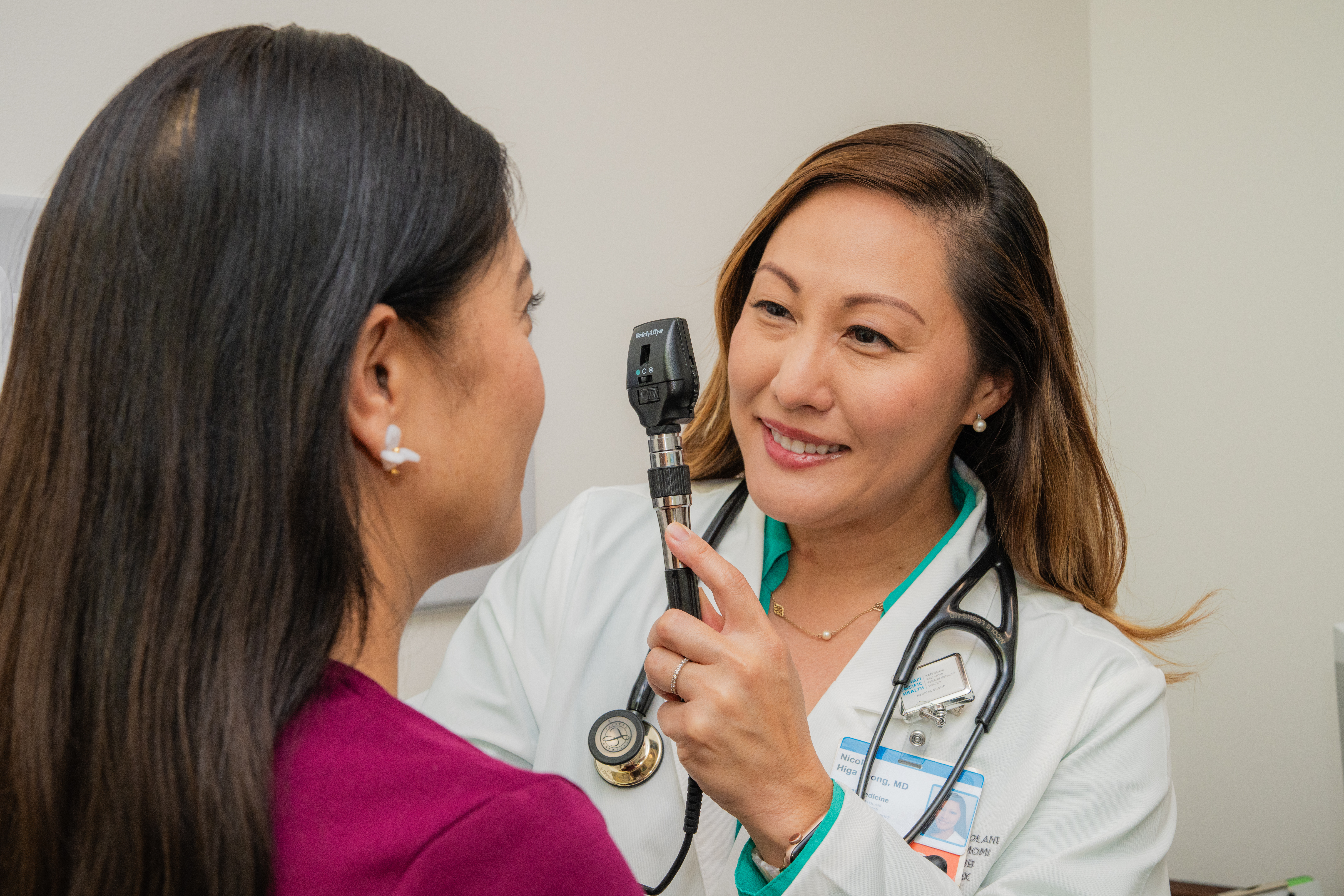 Primary care doctor looking into the eyes of a patient.