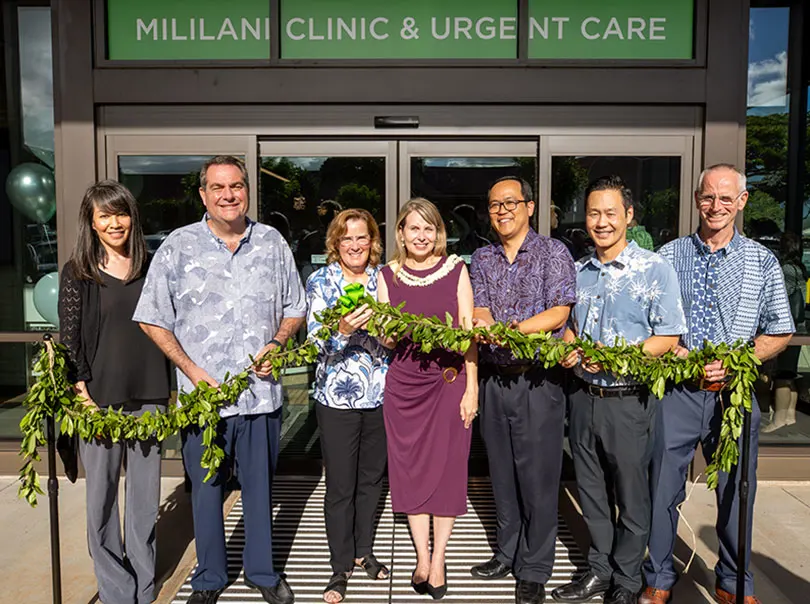 Group shot of healthcare leaders holding maile lei at blessing of new Mililani Clinic & Urgent Care.