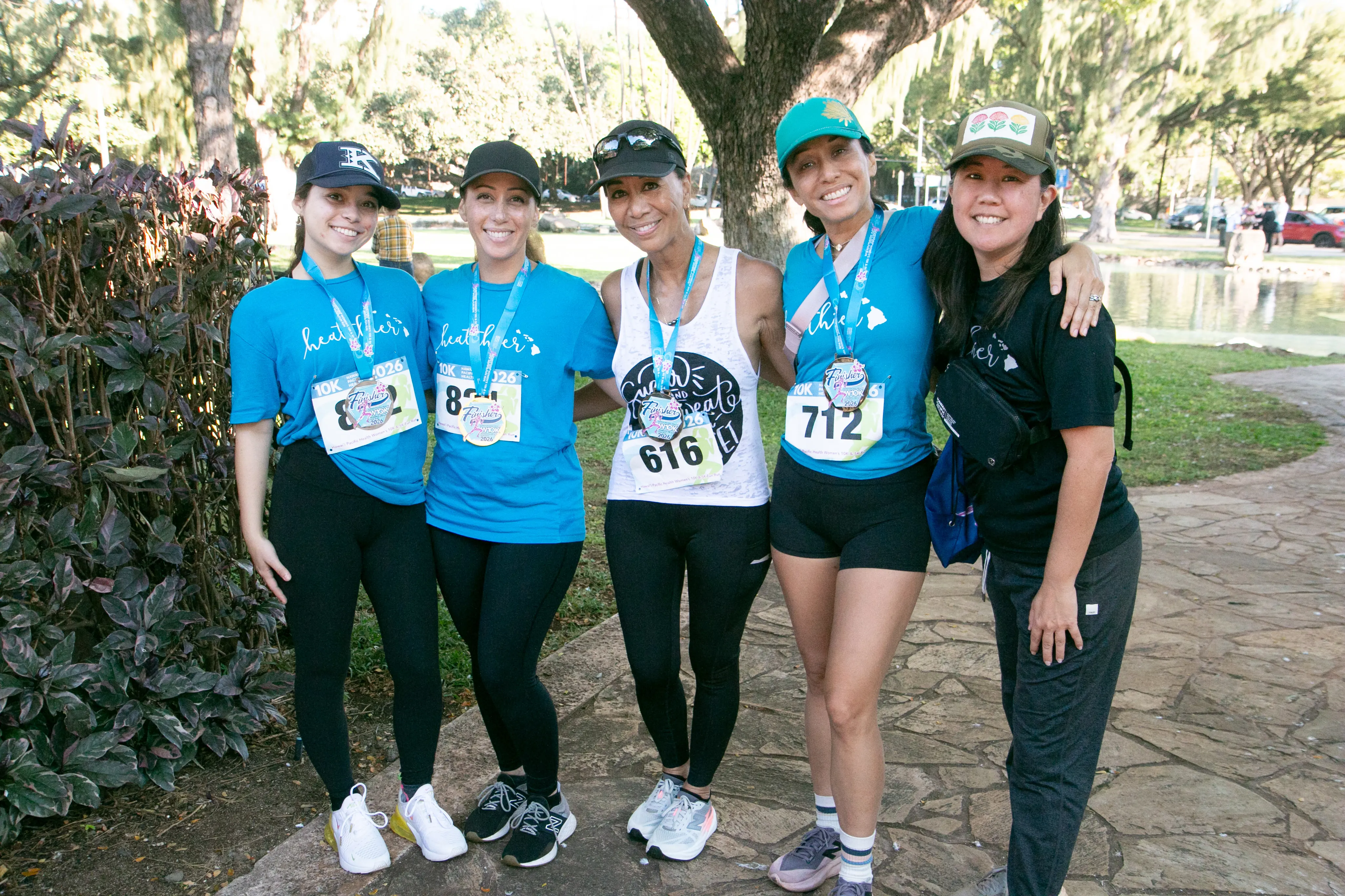 HPH employee 10K participants wearing their Healthier shirts and medals.