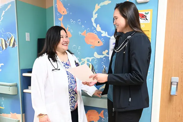 two female doctors stand in a hallway of a pediatric hospital
