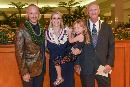 Honoree smiling and celebrating with her family.