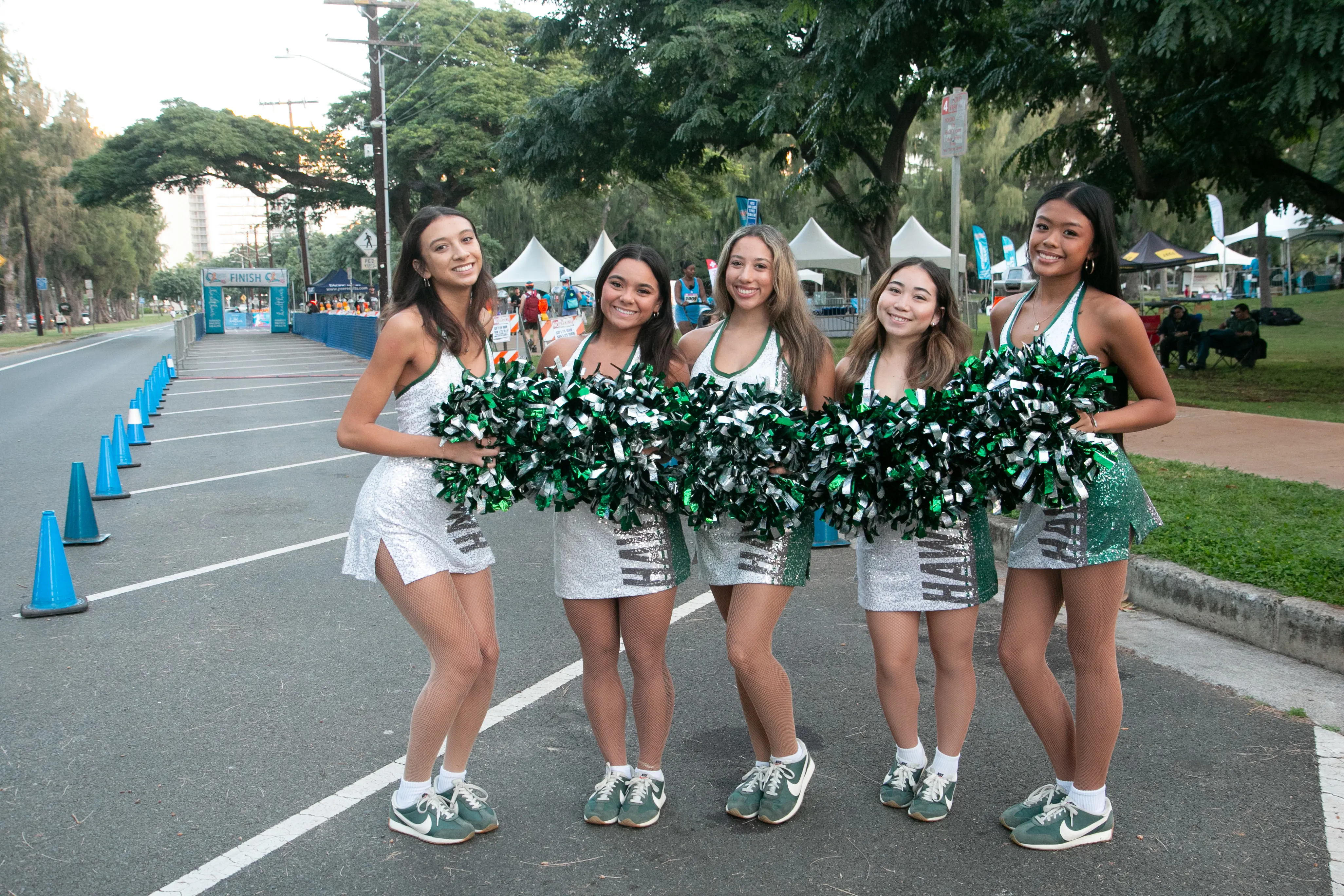 University of Hawaii Rainbow Dancers waiting near the finish line to cheer on the runners.