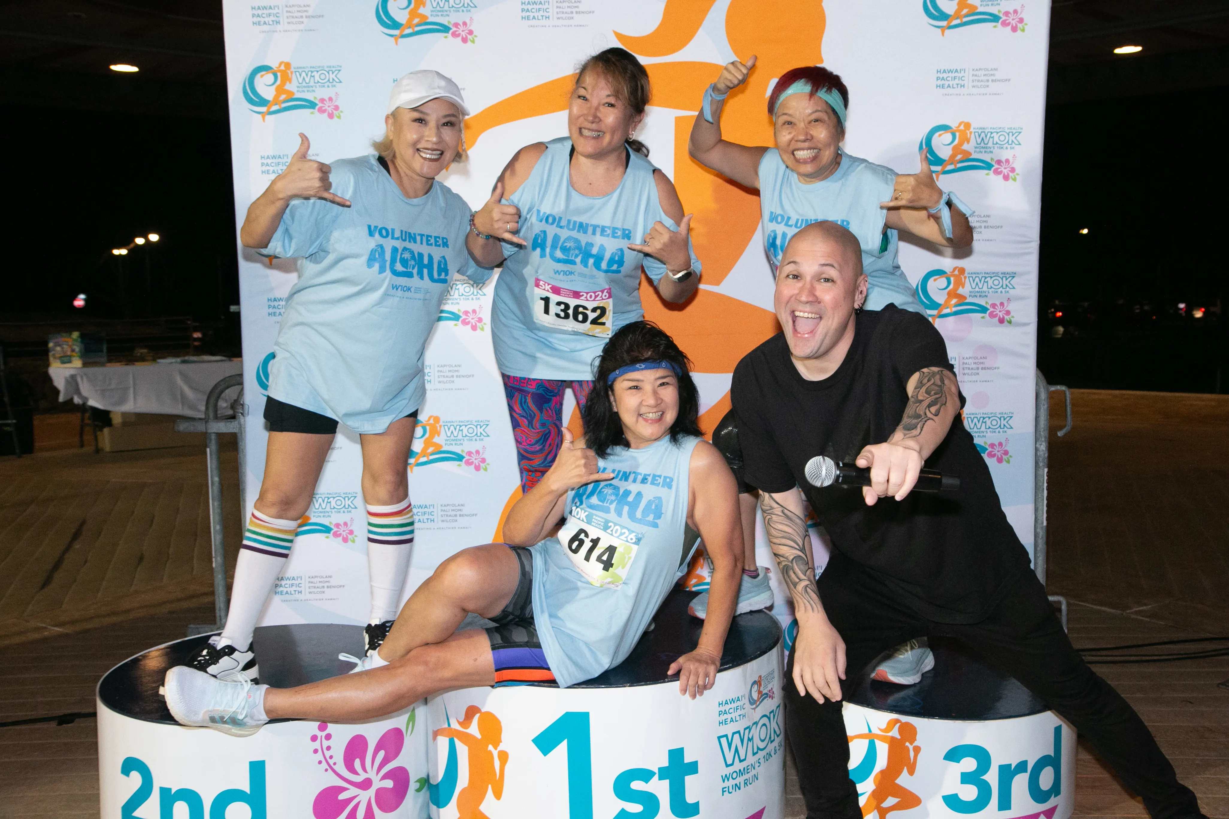 Zumba volunteers smiling with the race MC.