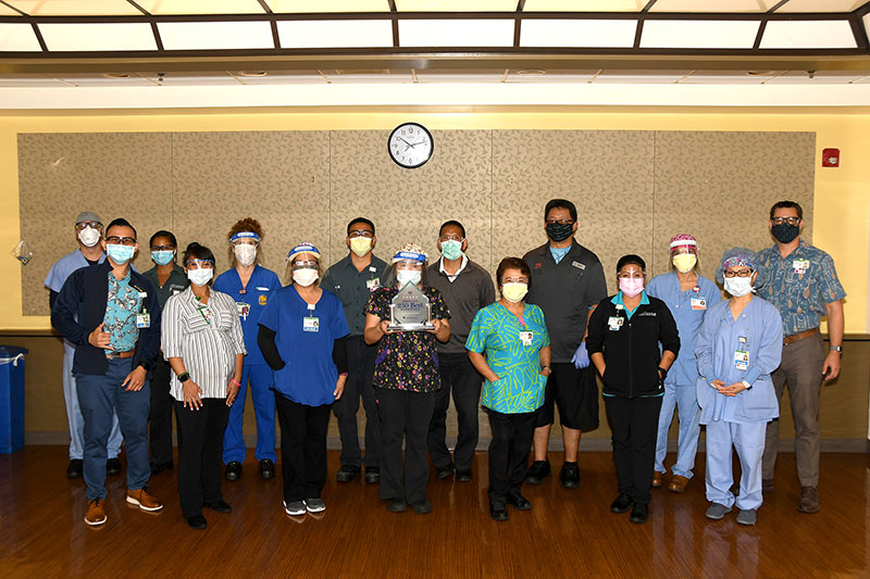 Group of Straub healthcare workers holding award trophy.