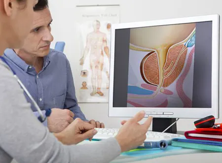 A doctor discusses treatment while showing data on a computer screen.