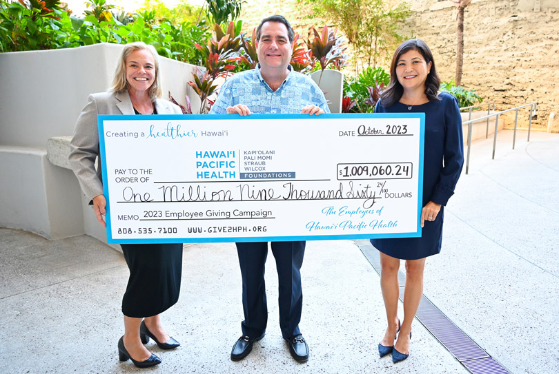 HPH leadership holding a giant check for over $1 million.