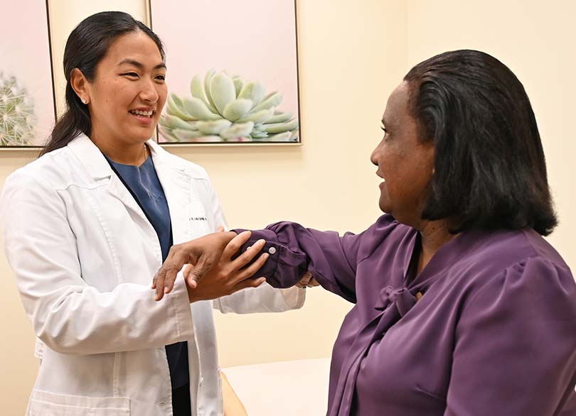 Doctor doing an exercise with a patient at the Kapiʻolani Women's Bone & Joint Clinic.