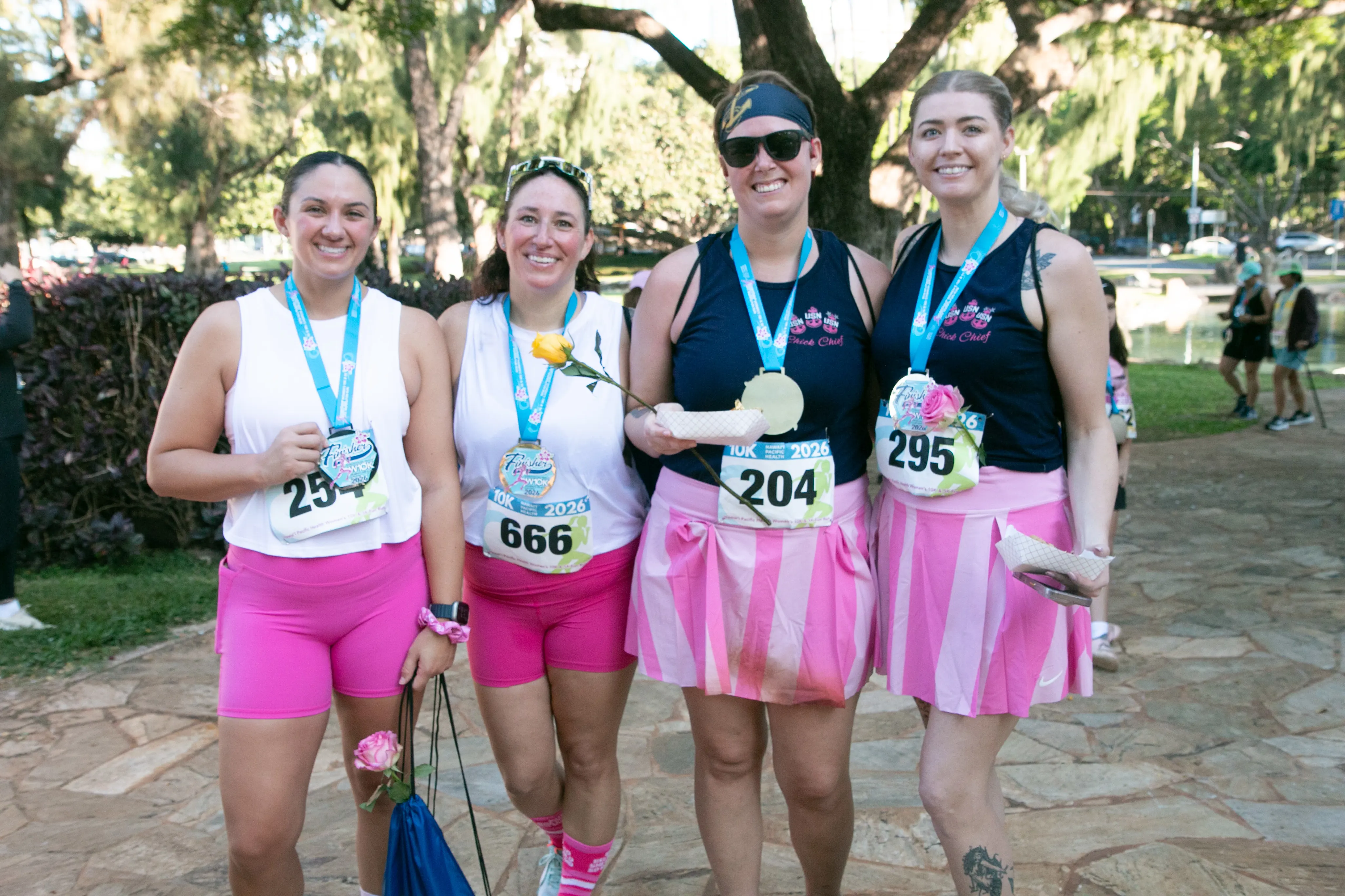 10K finishers smiling in their matching outfits.