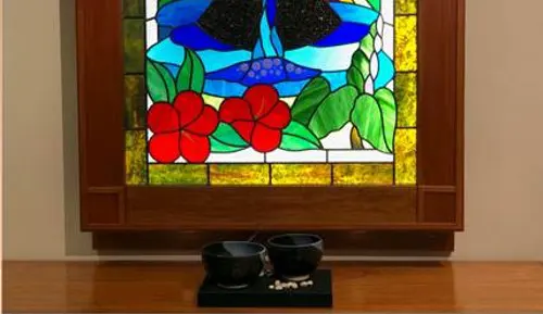 Small bowls in front of stained glass at Pali Momi Medical Center chapel.
