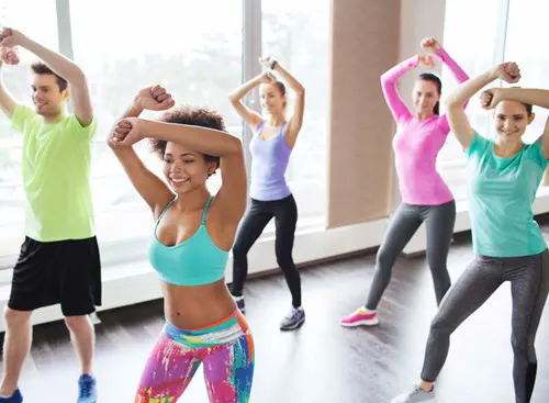 A group dances in an exercize class.