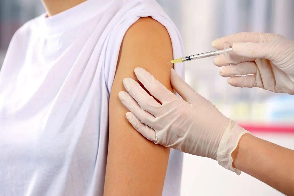 A patient getting a immunization shot.