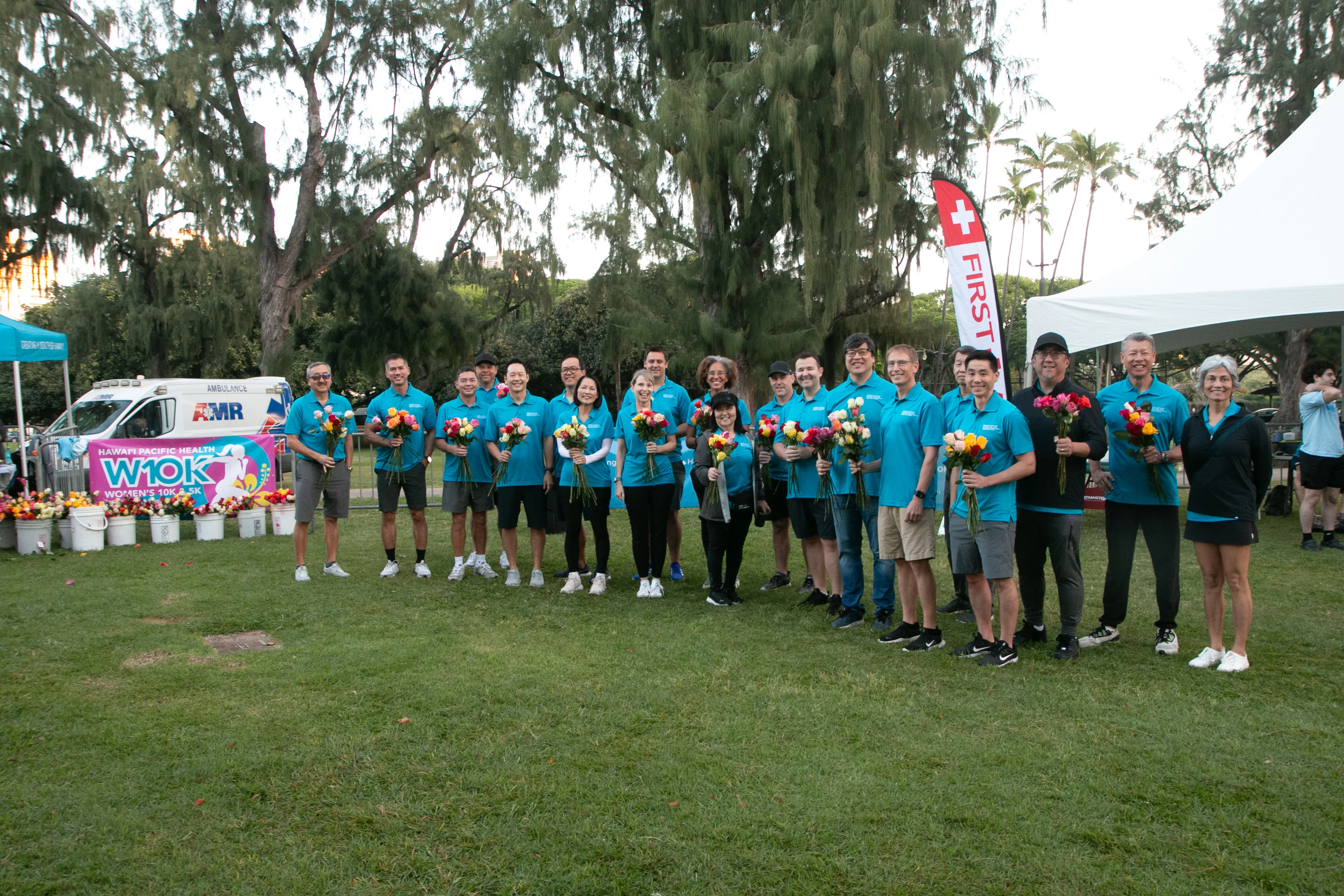 HPH employees holding roses for the race finishers.