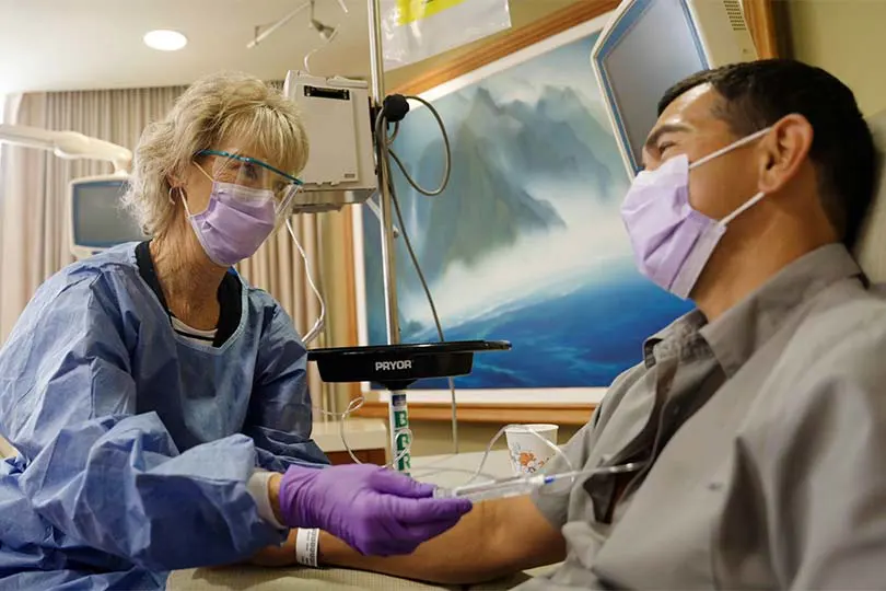 Hospital staff with patient in an infusion room.