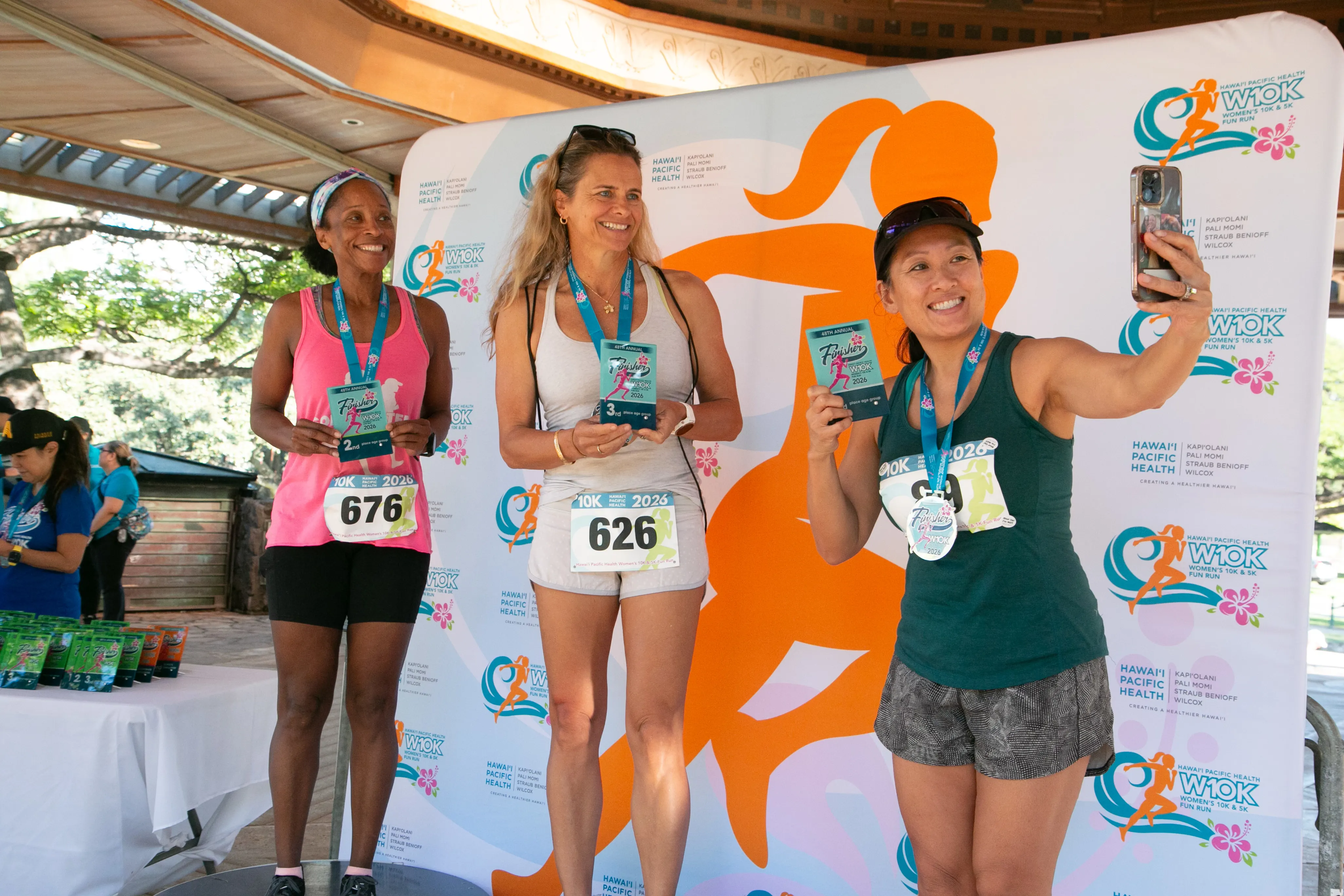 10K age division winners smiling with their awards.