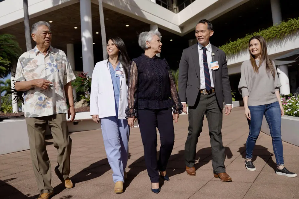 Providers and patients walking outside of Pali Momi Medical Center.