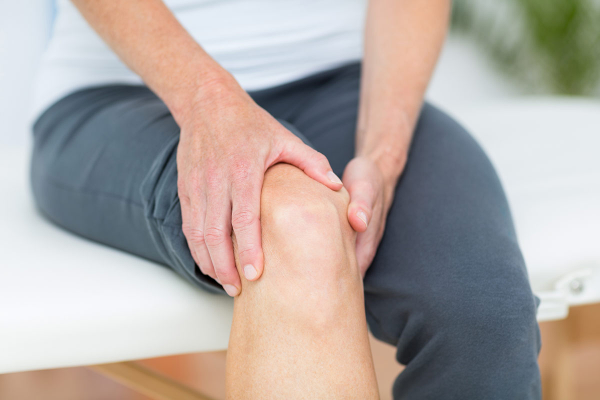 A patient clutching at sore knee.