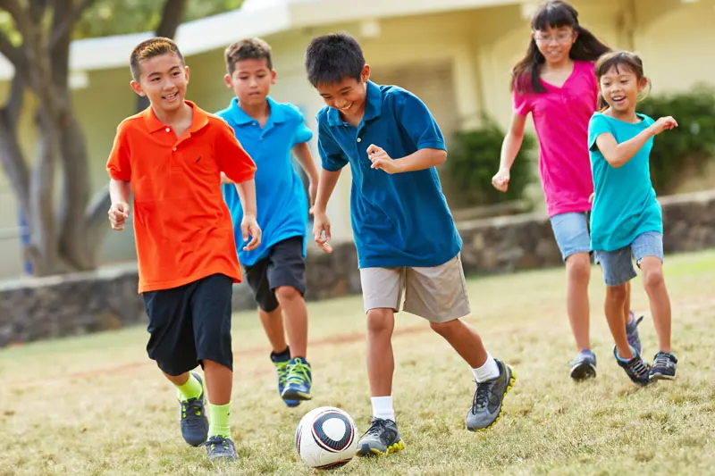 Kids playing soccer.
