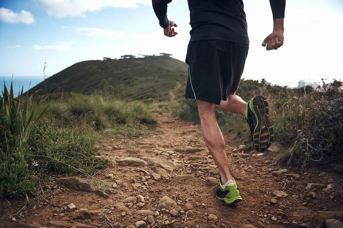 A man running on a dirt path.