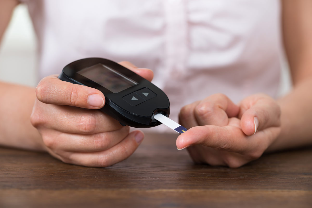A patient testing her blood for diabetes.