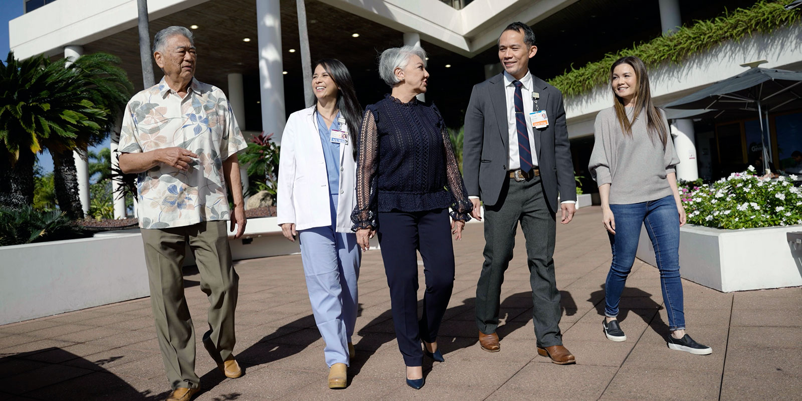 Providers and patients walking outside of Pali Momi Medical Center.
