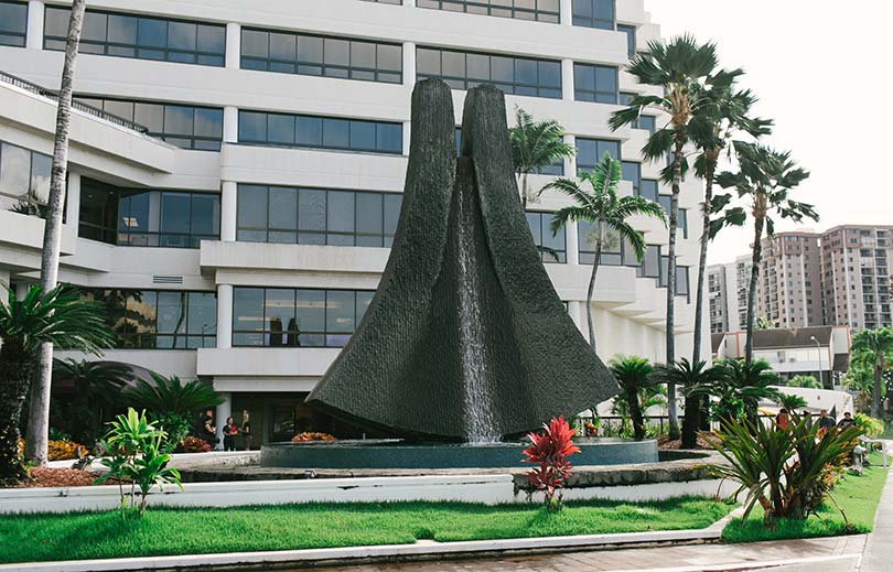 Exterior of the Pali Momi Medical Center building with its large distinctive fountain sculpture.